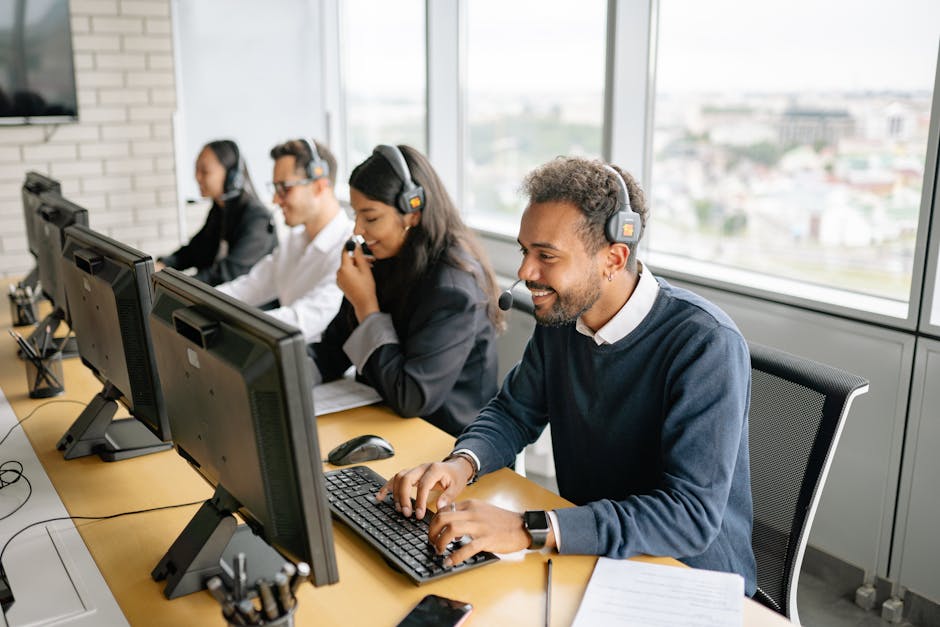 A diverse team of call center agents working together in an office setting.
